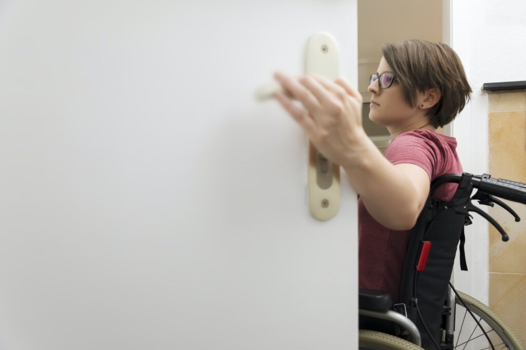 disabled woman at the open door with space for your content