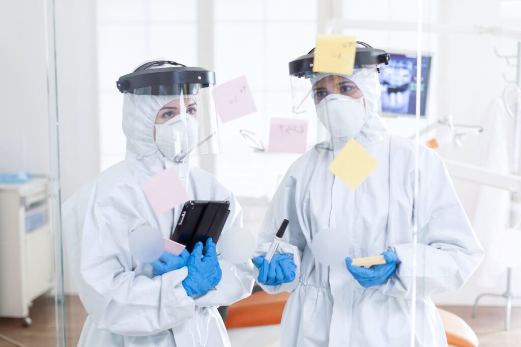 Dentist during coronavirus wearing ppe suit